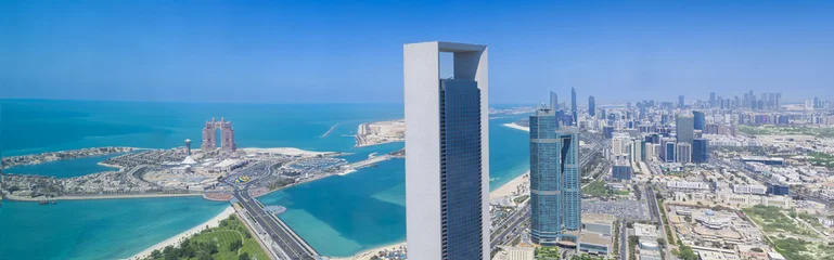 Fototapeten Abu Dhabi Wide panorama of the Abu Dhabi city skyline featuring waterfront skyscrapers along the Corniche, and the Arabian Gulf in the United Arab Emirates.  © eskystudio