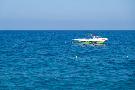 June 26, 2023, Antalya, Turkey. A vibrant parasailing boat navigates the serene blue waters of the ocean, showcasing a perfect day for water activities under a clear sky.