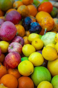 Diverse Assortment of Fresh Tropical Fruits and Citrus in Vibrant Outdoor Market Display