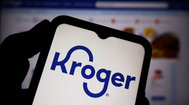 Kroger logo displayed on a smartphone screen held in a hand