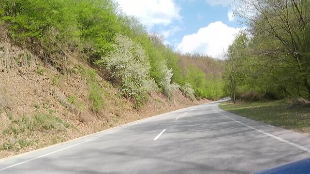Spring uphill road ride video on mountain pass of Pezinska Baba, Little Carpathians low mountain range, western Slovakia, central Europe.
