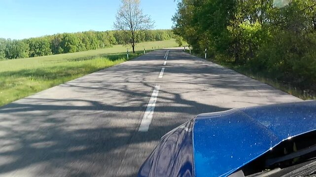 Spring local road ride across Krupina Basin towards historical town of Krupina, meadows on the left side and forested area, mostly broadleaf forest on right side of the road.