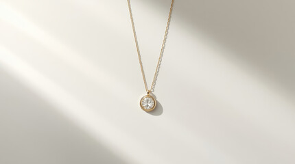 Fototapeta premium Gold pendant necklace with sparkling gemstone and soft shadowing evoking elegant calm