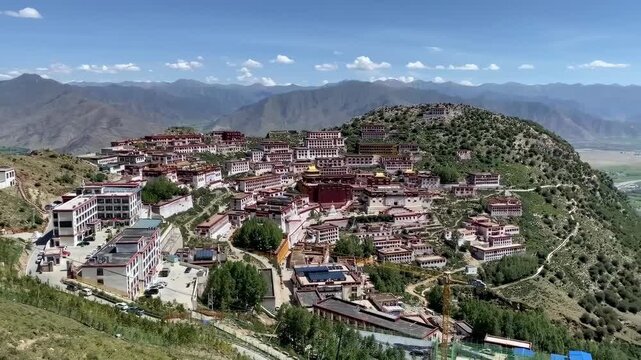 Panoramic view of rebuilt Ganden Monastery in Dagz&ecirc;, Tibet, showcasing sacred Tibetan Buddhist architecture and Himalayan mountain landscape in 2025