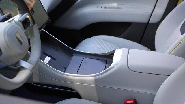 Close-up of cup holders and mobile charging station inside Avatr 11 luxury EV. Showcasing practical interior design and smart connectivity features. Ideal for automotive and tech visuals.