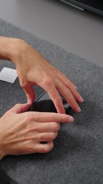 Person applying a transparent tempered glass screen protector onto a smartphone display, ensuring device protection and maintenance.
