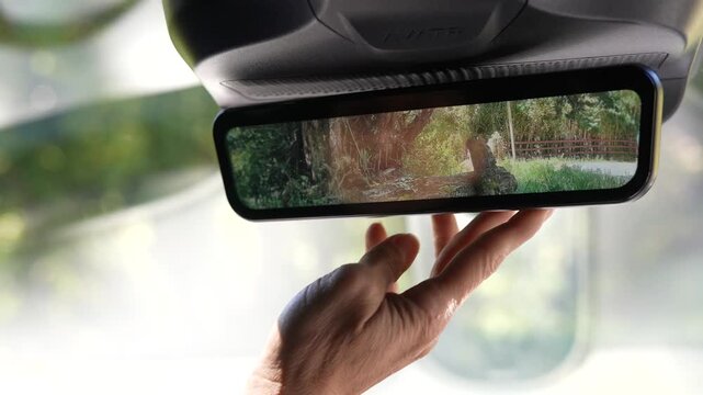 Close-up of rearview mirror in Avatr 11 with reflection of road and interior cabin. Ideal for driving scenes, automotive visuals, and safety-focused content.