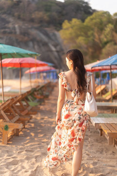 Woman in dress on the beach.