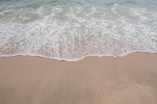 Sea blue wave with sand beach at coast vacation holidays tropical.