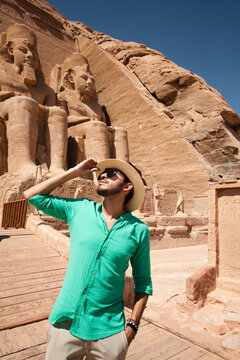 Traveler exploring ancient Egyptian architecture at Abu Simbel