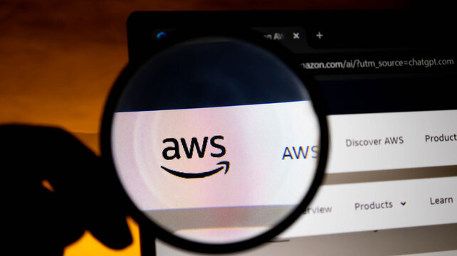 Magnifying glass over the amazon web services aws logo on a computer screen