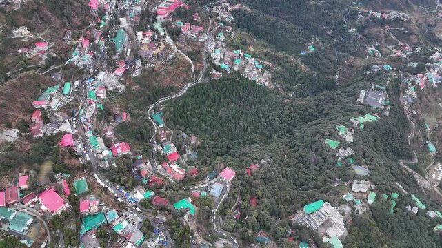 Scenic aerial and street level views of Mussoorie, Uttarakhand, featuring misty hills, colonial charm, mountain roads, pine forests, cafes, and vibrant tourist life in the Queen of Hills.
