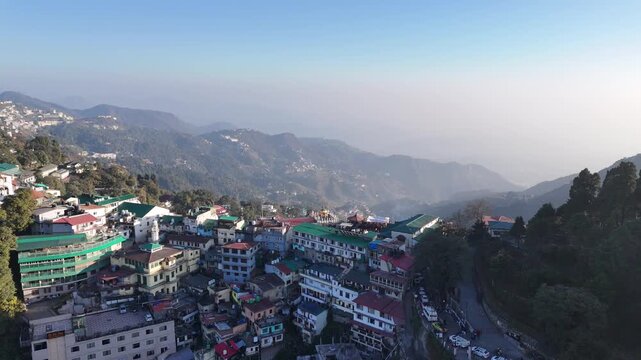 Scenic aerial and street level views of Mussoorie, Uttarakhand, featuring misty hills, colonial charm, mountain roads, pine forests, cafes, and vibrant tourist life in the Queen of Hills.
