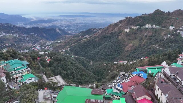 Scenic aerial and street level views of Mussoorie, Uttarakhand, featuring misty hills, colonial charm, mountain roads, pine forests, cafes, and vibrant tourist life in the Queen of Hills.