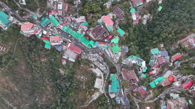 Scenic aerial and street level views of Mussoorie, Uttarakhand, featuring misty hills, colonial charm, mountain roads, pine forests, cafes, and vibrant tourist life in the Queen of Hills.