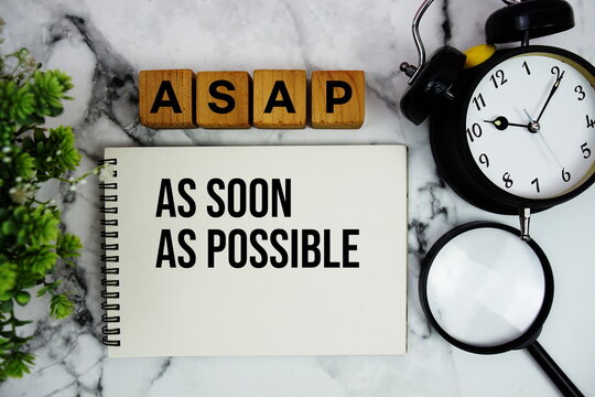 ASAP As Soon As Possible text with alarm clock and magnifying glass on marble background