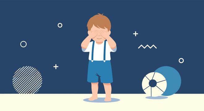Cute little boy wearing suspenders and blue shorts covering his eyes with his hands against a dark blue decorative background.