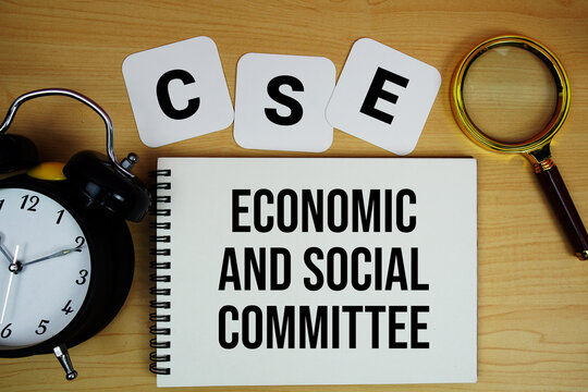 CSE Economic and Social Committee text written on notepad with magnifying glass and alarm clock on wooden background