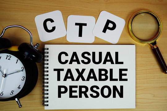 CTP Casual Taxable Person text written on notepad with magnifying glass and alarm clock on wooden background