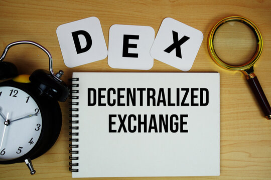 DEX Decentralized Exchange text written on notepad with magnifying glass and alarm clock on wooden background
