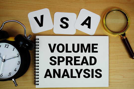 VSA Volume Spread Analysis text written on notepad with magnifying glass and alarm clock on wooden background
