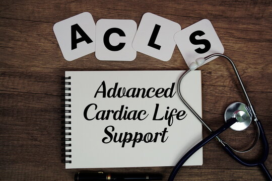 ACLS Advanced Cardiac Life Support text written on notepad with stethoscope on wooden background