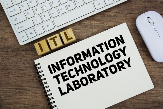 ITL Information Technology Laboratory message with keyboard and optical mouse on wooden background