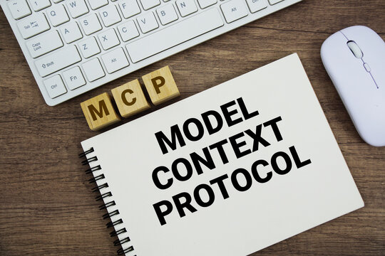 MCP Model Context Protocol message with keyboard and optical mouse on wooden background