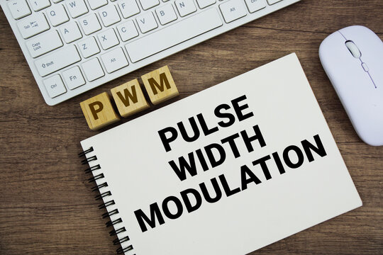 PWM Pulse Width Modulation message with keyboard and optical mouse on wooden background