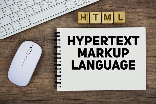 HTML HyperText Markup Language message with keyboard and optical mouse on wooden background