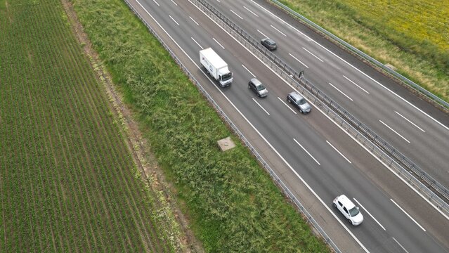 Aerial view of a highway with cars and truck passing through the countryside.