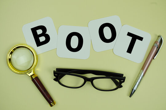 BOOT alphabet letters with magnifying glass, eye glasses and pen on yellow background