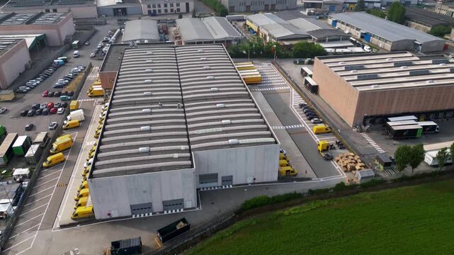 Industrial Estate Aerial View: A sprawling industrial estate is captured from an elevated perspective, revealing its expansive layout, logistical operations, and architectural design
