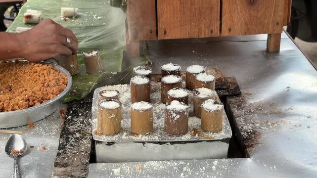 An Asian man selling traditional food checks the doneness of steamed Putu cake to ensure perfect texture a