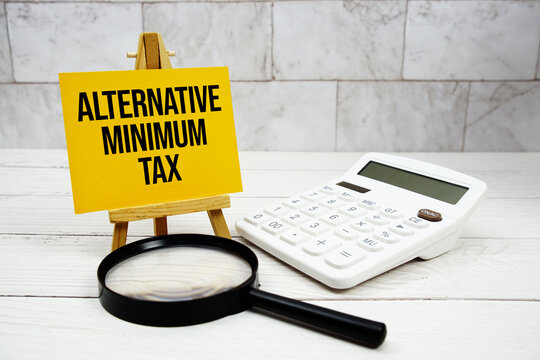 Alternative Minimum Tax text with calculator and magnifying glass