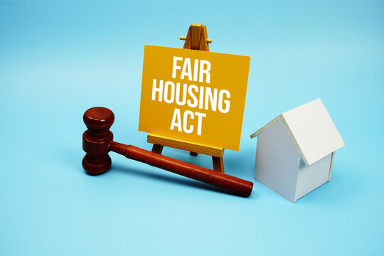 Fair Housing Act text with judgment gavel and house model on blue background