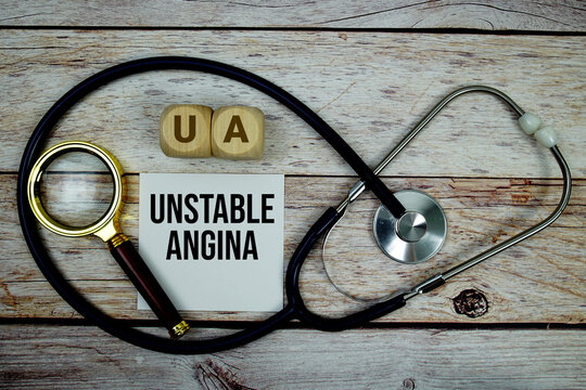 Unstable Angina (UA) text with stethoscope and magnifying glass on wooden background
