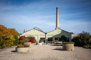 Fototapeta premium Historic Industrial Building With Tall Chimney