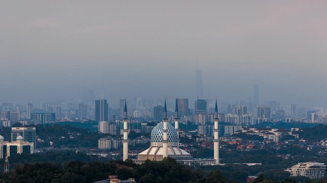 Time Lapse of Sultan Salahuddin Abdul Aziz Shah Mosque in Shah Alam at Sunset with Magenta Sky and Moving Clouds, Selangor, Malaysia. Tilt down motion.