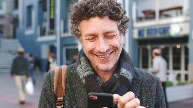 Phone, business and happy man in city for typing, communication or reading for lecturer job. Teacher, laugh and mature person scroll with funny, humor and sharing knowledge on social media in street