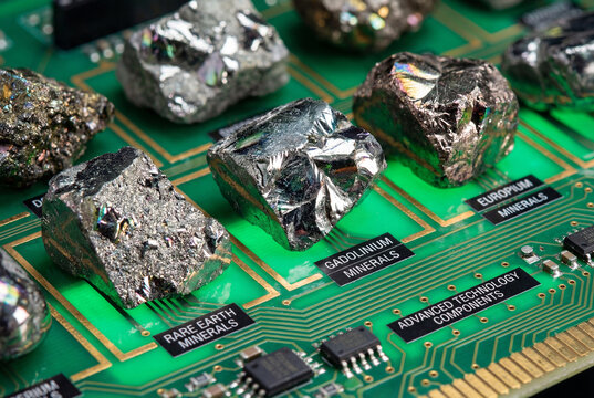 Rare earth element minerals like gadolinium and europium on a green printed circuit board