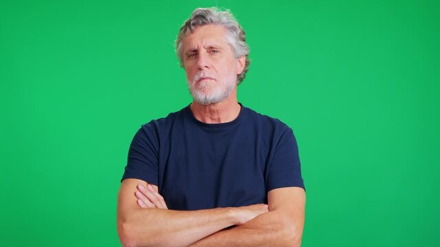 Mature caucasian man looking defiant on green screen