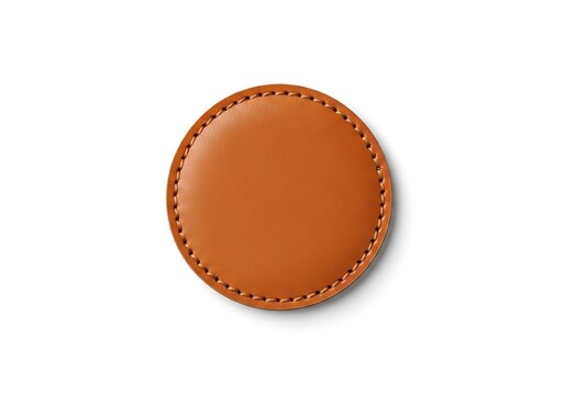 A round tan brown circle leather patch isolated on a clean white background featuring visible stitched edges for fashion accessory and craft projects design.