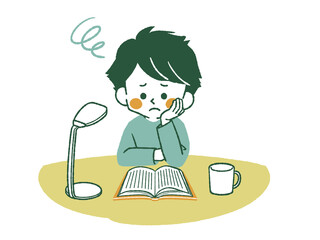 Obraz premium 困った表情で本を読んでいる男の子