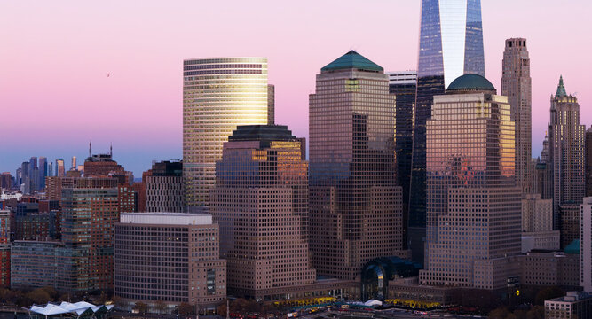 New York panoramic dusk metropolis. NYC panoramic view of Lower Manhattan skyline at dusk. New York City aerial panoramic skyline at dusk. New York panoramic landscape at dusk.