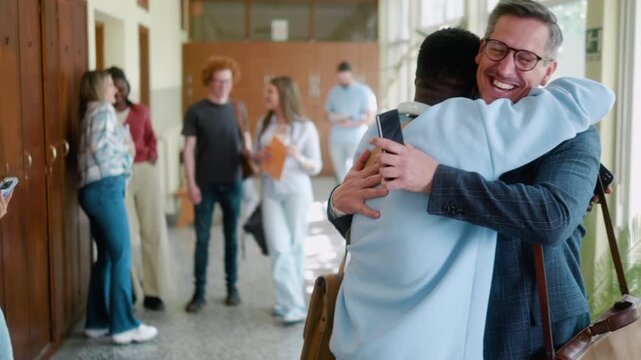 Excited African student hugs professor in university hallway while celebrating passing exam and academic success. Happiness, pride and joyful achievement.