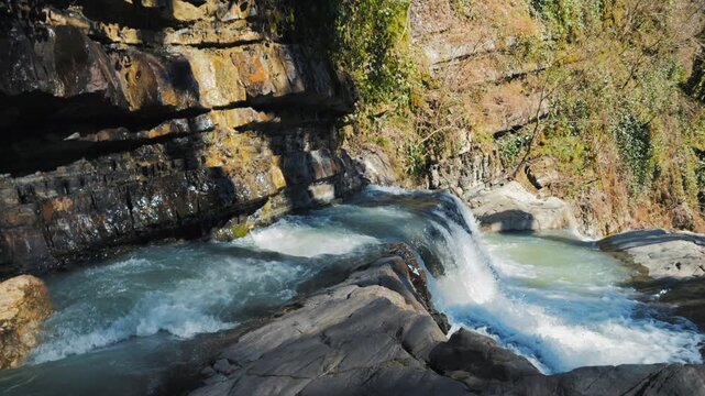 Slow Motion Dolly In: Moving Towards the Edge of a Forest Waterfall
