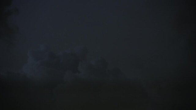 Havy Dark stormy clouds with lightning in night sky. Dramatic stormy thunderstorm, heavy weather, atmospheric background.