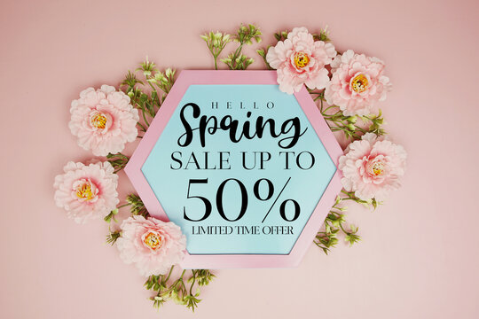 Spring Sale up to 50% Off text on hexagon background with beautiful flowers blooming