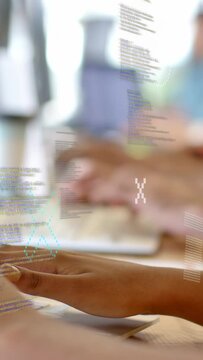Vertical video: Dev team typing on laptops, first keypress spawning code overlay for teamwork